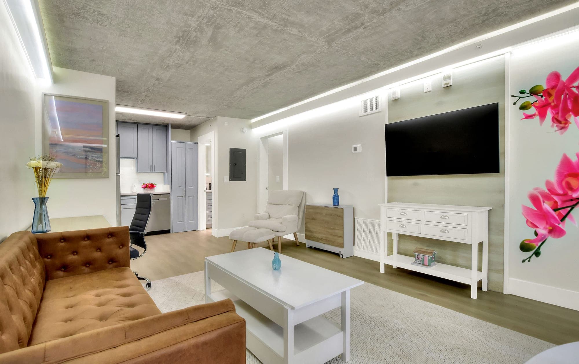 Cozy one-bedroom living room with exposed concrete ceiling